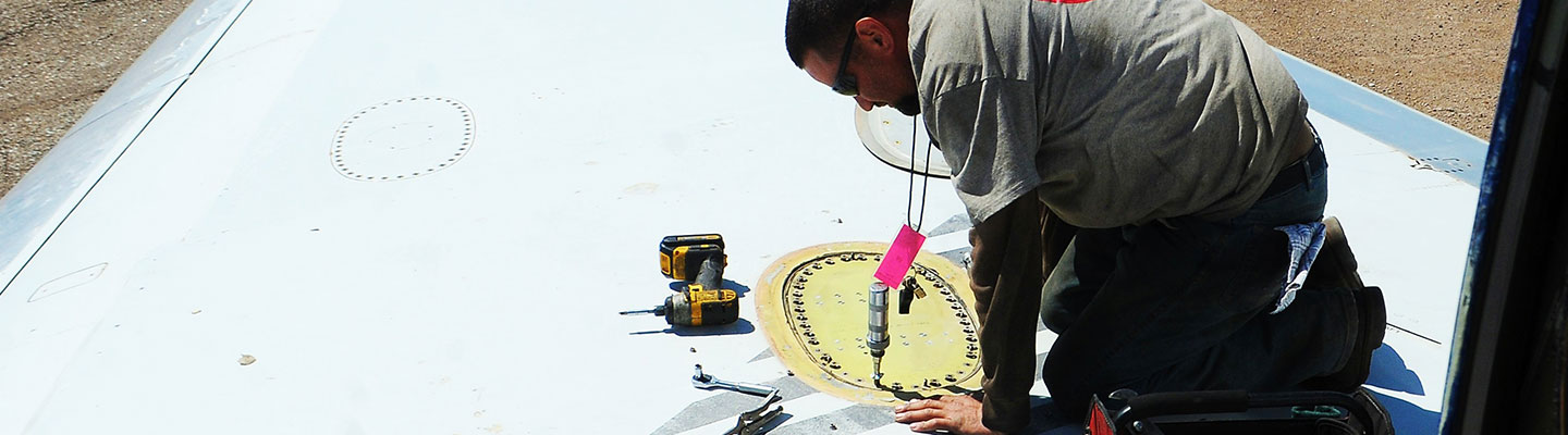 man working on an airplane wing